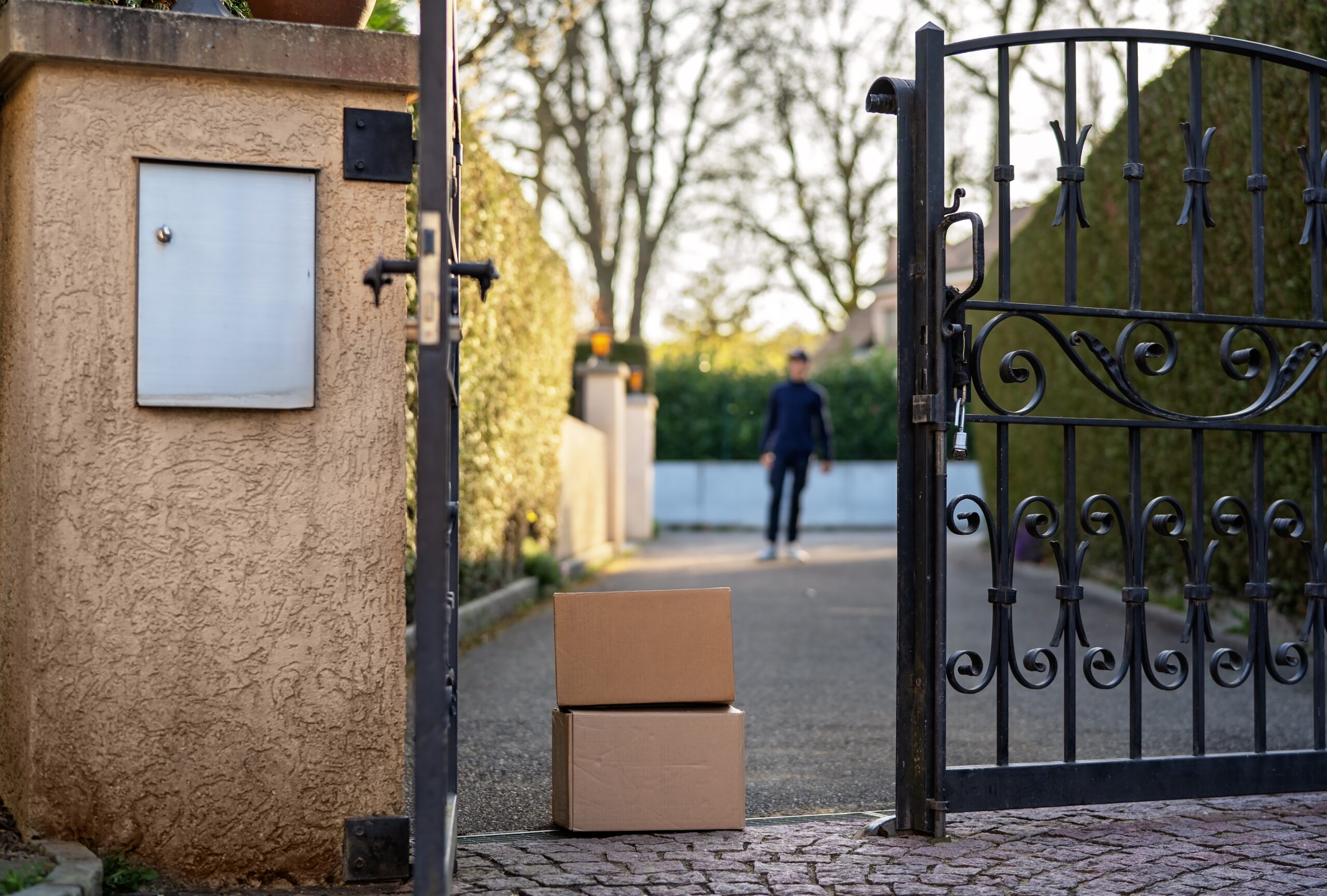 two brown packages stacked up in front of an open gate