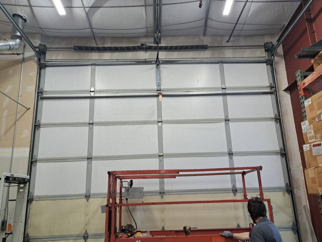 Garage door services in South King County | large white commercial garage door with a lift in front of it 