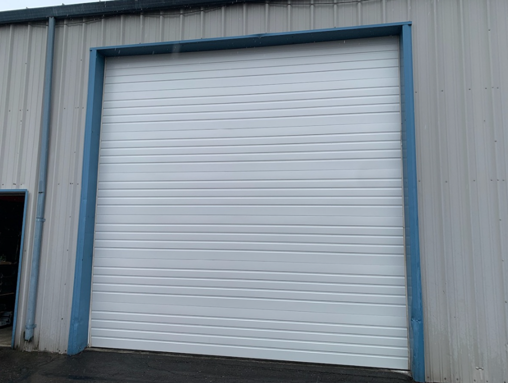 white commercial garage door with blue trim