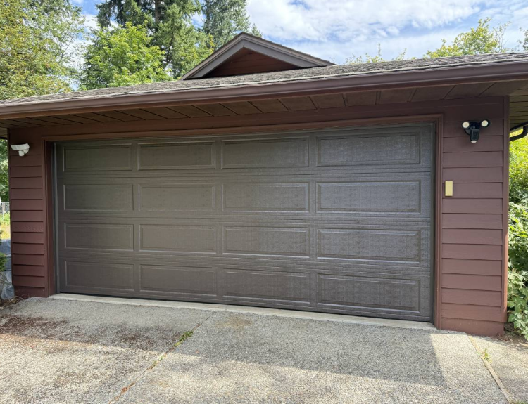 Brown garage door on a brown home installed by Lakeside Doors