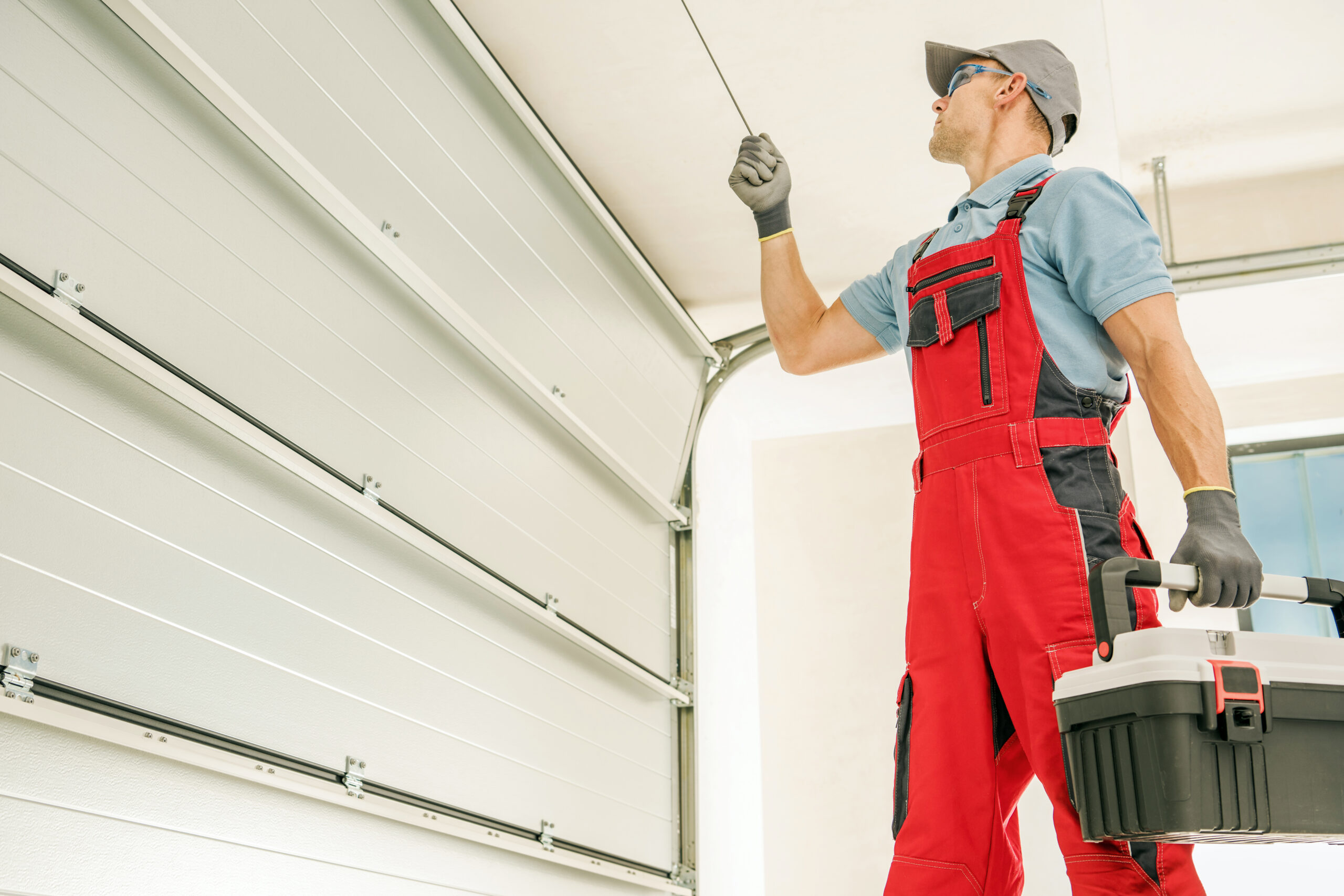 Modern Garage Doors Installer Man doing garage door maintenance | garage door maintenance checklist