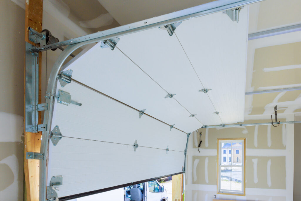 A June Garage Door Maintenance Checklist: Preventing Hidden Rust on PNW Tracks Installation of rolling shutters plastic garage doors in new house