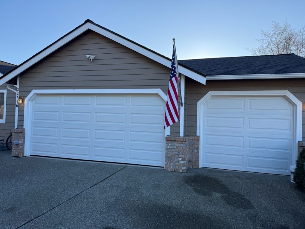 How to Fix a Noisy Garage Door By Auditing Its Decibel Levels two white garage doors