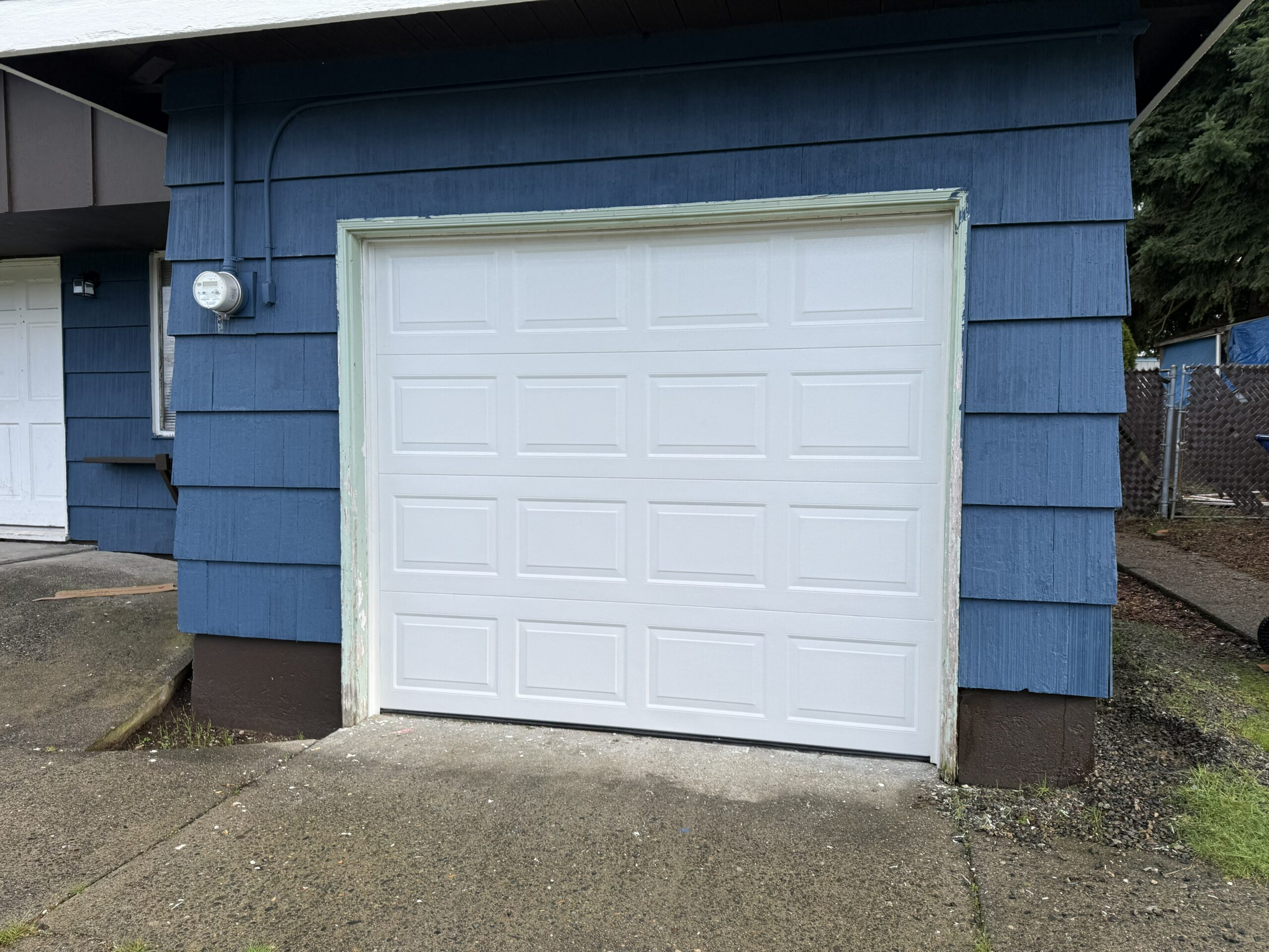 newly painted and repaired white garage door