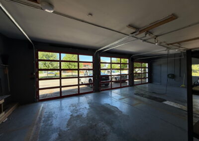 inside of a garage with new commercial garage doors that are glass windows