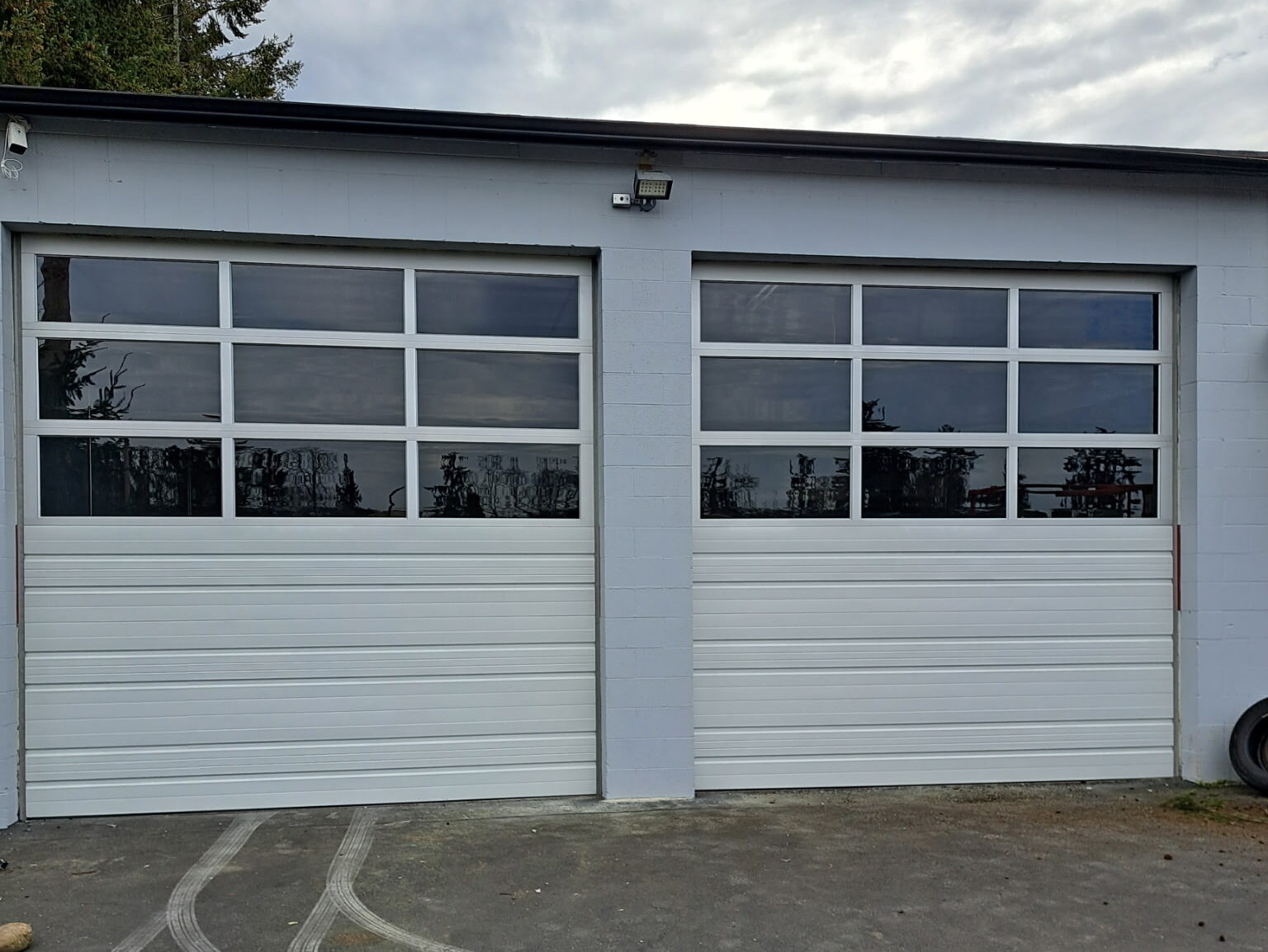 Commercial garage door installation with Hormann 254p garage doors with glass windows