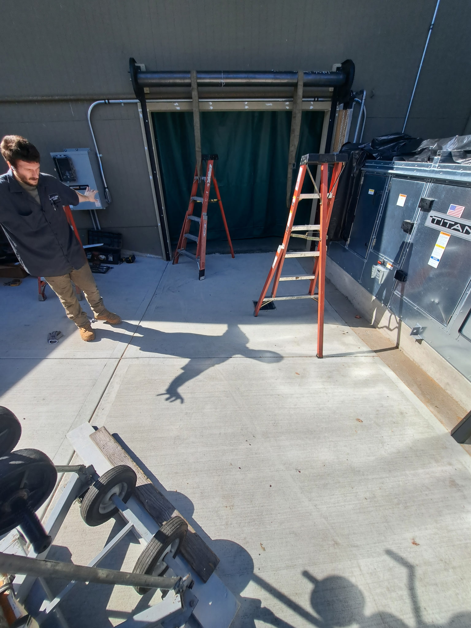 Worker doing a commercial garage door repair service | garage door repair and maintenance